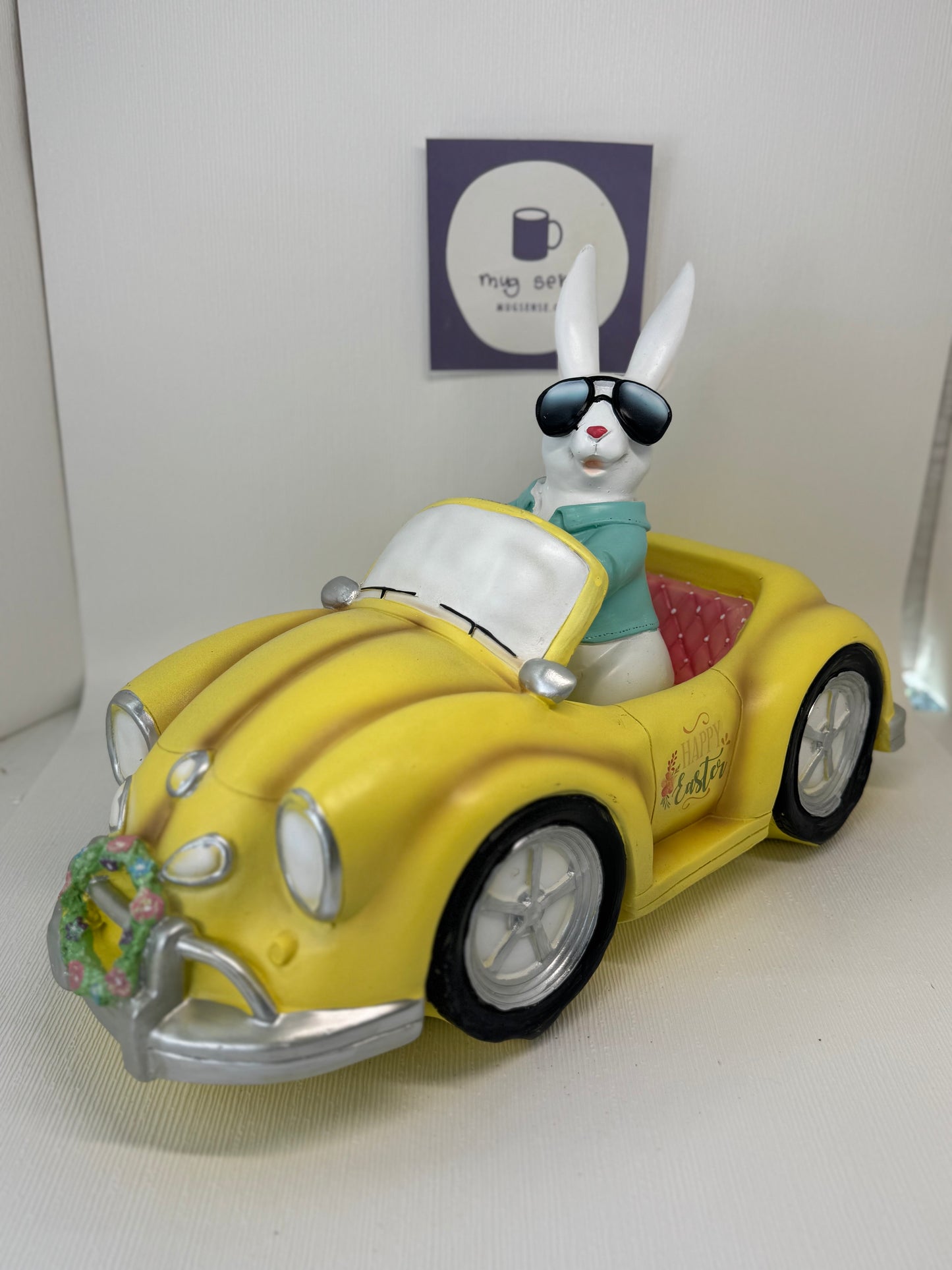Huge Easter Bunny with Sunglasses Driving Yellow Volkswagen