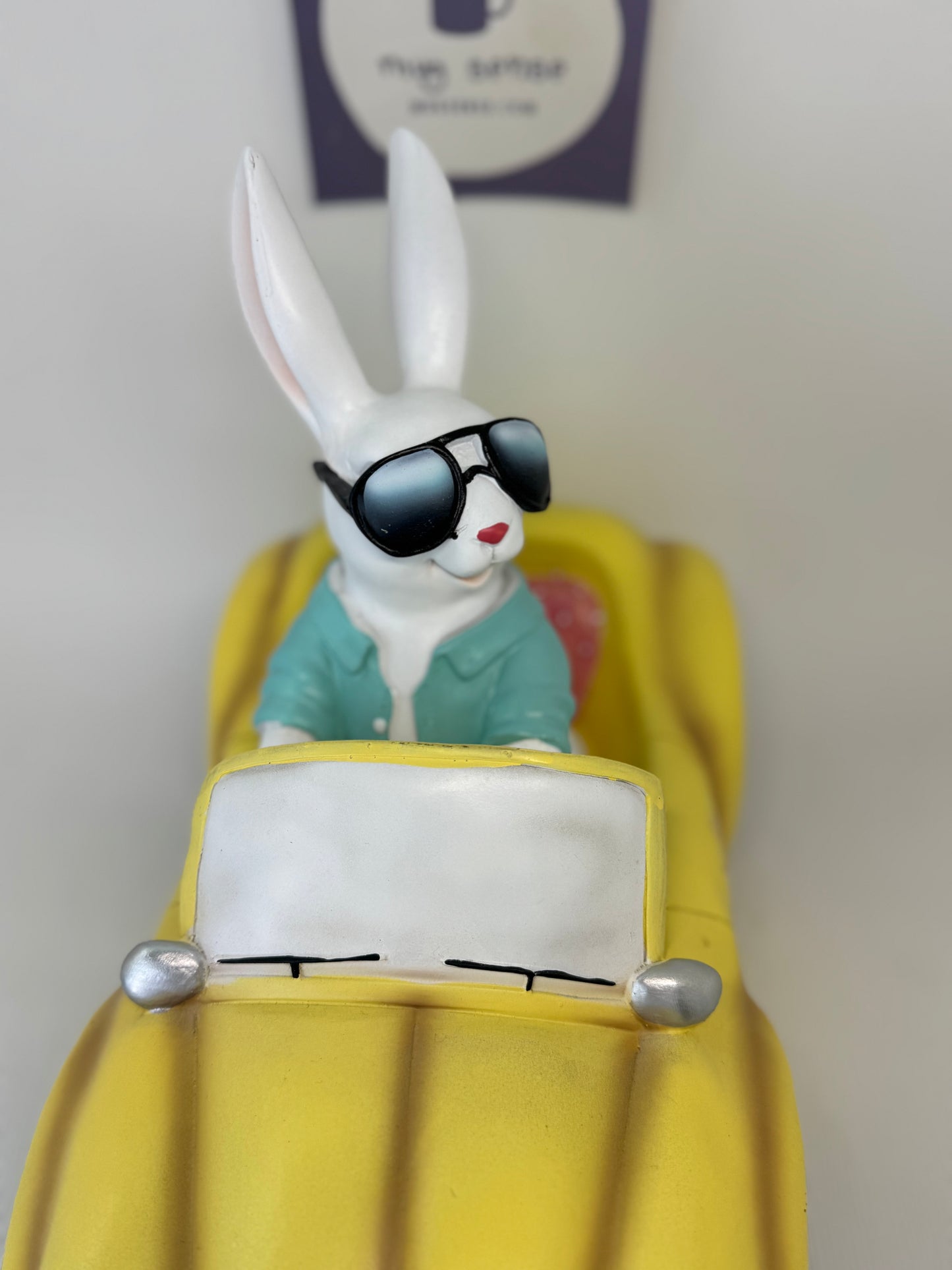 Huge Easter Bunny with Sunglasses Driving Yellow Volkswagen